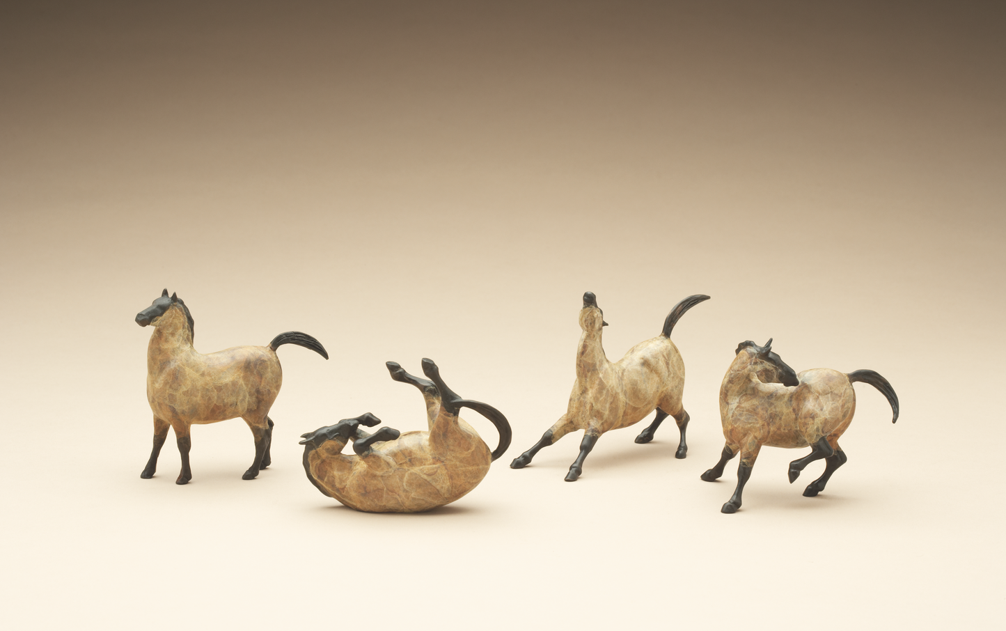 four bronze mini horses