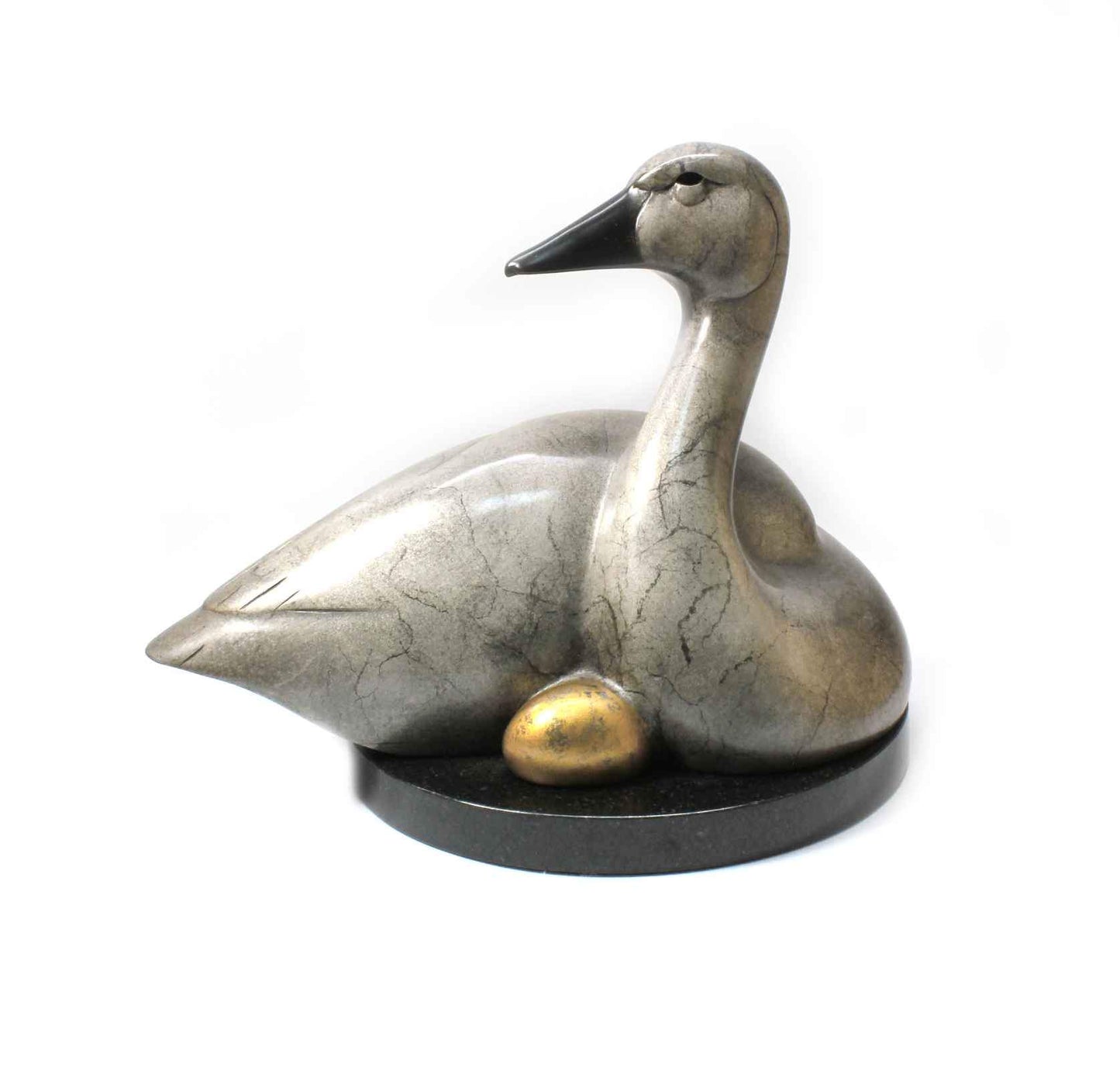 A Gray swan nestling a golden egg. Bronze sculpture by Tim Cherry. Sorrel Sky Gallery.