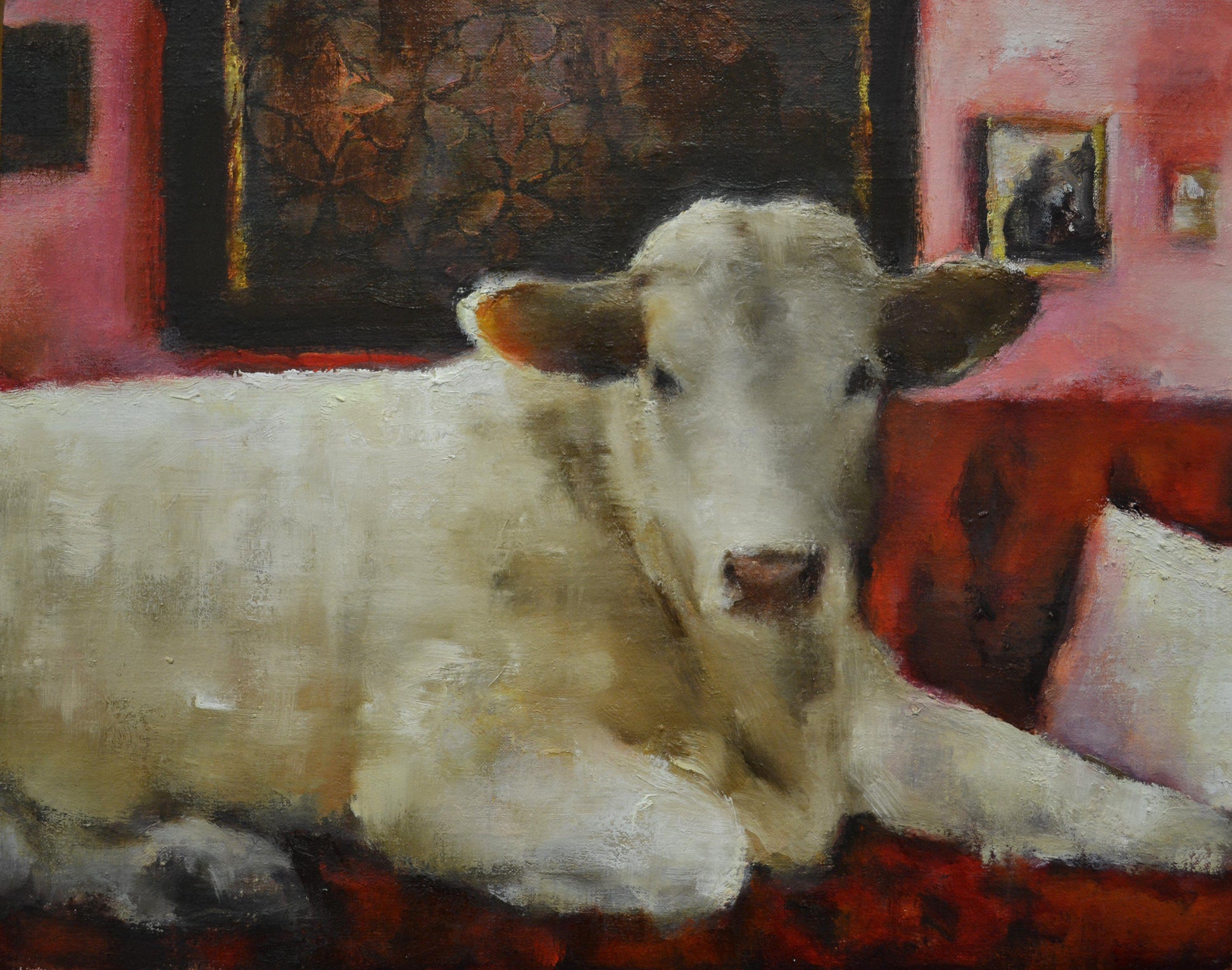 A White Cow laying on a Red sofa.  Whimsical painting by Elsa Sroka.