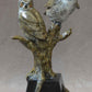Two horned owls sitting on a branch. Bronze Sculpture by Jim Eppler at Sorrel Sky gallery