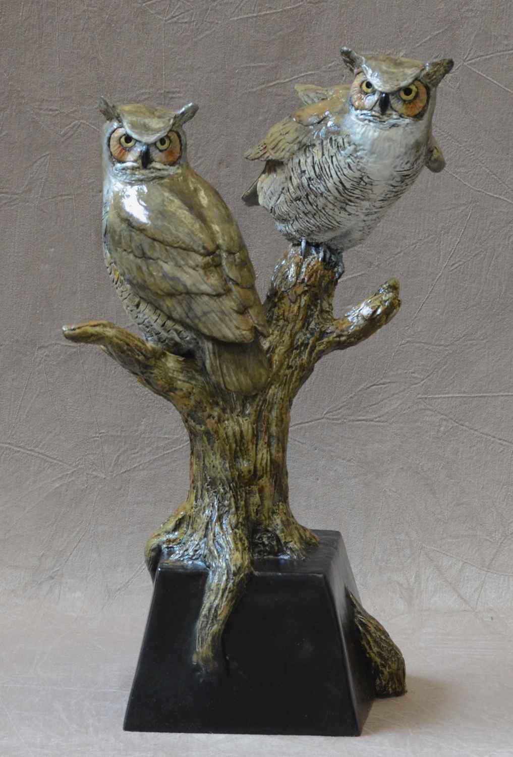 Two horned owls sitting on a branch. Bronze Sculpture by Jim Eppler at Sorrel Sky gallery